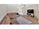 Bright living room with hardwood floors, neutral walls, large sofa, and a ceiling fan at 635 Oakside Pl, Acworth, GA 30102