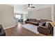 Inviting living room features hardwood floors, a ceiling fan, and a comfortable brown sectional sofa at 635 Oakside Pl, Acworth, GA 30102