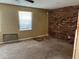 Bedroom with a brick accent wall and window at 6354 Shannon Pkwy # 13C, Union City, GA 30291
