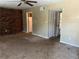Living room featuring a brick wall, ceiling fan, and access to the kitchen at 6354 Shannon Pkwy # 13C, Union City, GA 30291