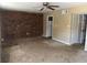 Living room featuring a brick wall, ceiling fan, and access to the kitchen at 6354 Shannon Pkwy # 13C, Union City, GA 30291