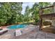 Home's backyard with inviting deck overlooking a beautiful pool at 1300 Sever Woods Dr, Lawrenceville, GA 30043