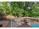 Back deck overlooking a pool and fenced in backyard with mature trees and landscaping at 1300 Sever Woods Dr, Lawrenceville, GA 30043