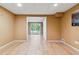 Finished basement features laminate wood floors and a sliding glass door leading to a backyard at 1300 Sever Woods Dr, Lawrenceville, GA 30043