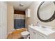 Bathroom includes a shower with curtain, a white vanity, toilet and an ornate mirror at 1300 Sever Woods Dr, Lawrenceville, GA 30043