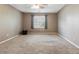 Spacious bedroom features neutral paint, carpet, and large window with gray curtains for natural light at 1300 Sever Woods Dr, Lawrenceville, GA 30043
