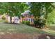 Charming two-story brick home featuring mature trees, a well-maintained lawn, and a two-car garage at 1300 Sever Woods Dr, Lawrenceville, GA 30043