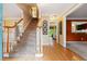 Inviting foyer with hardwood floors, carpeted staircase, and views into the adjacent living spaces at 1300 Sever Woods Dr, Lawrenceville, GA 30043