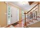 Bright entryway featuring hardwood floors, a staircase with wood railing, and sidelight windows at 1300 Sever Woods Dr, Lawrenceville, GA 30043