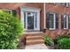 Elegant front entrance with brick steps, detailed trim, and lush landscaping providing curb appeal at 1300 Sever Woods Dr, Lawrenceville, GA 30043