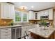 Updated kitchen with stainless steel appliances, granite countertops, and custom cabinetry at 1300 Sever Woods Dr, Lawrenceville, GA 30043