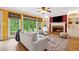 Bright living room with hardwood floors, built-in shelves, a fireplace, and large windows with wooded views at 1300 Sever Woods Dr, Lawrenceville, GA 30043
