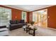 Comfortable living room with large windows, neutral carpet, a gray sofa, and views into the foyer at 1300 Sever Woods Dr, Lawrenceville, GA 30043
