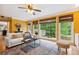 Bright living room with large windows, hardwood floors, and a comfortable seating area at 1300 Sever Woods Dr, Lawrenceville, GA 30043