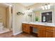 Main bathroom with double vanity, shower with glass doors, and view into main bedroom at 1300 Sever Woods Dr, Lawrenceville, GA 30043