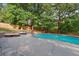 Backyard inground pool with lounge chairs and umbrellas next to grass at 1300 Sever Woods Dr, Lawrenceville, GA 30043