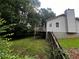 A backyard view featuring a wooden fence and some mature trees at 1504 Colt Ridge Se Ln, Mableton, GA 30126