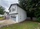 Side view of home, featuring a garage and a small yard at 1504 Colt Ridge Se Ln, Mableton, GA 30126