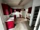 Picture of a kitchen featuring red cabinets and matching countertops at 1504 Colt Ridge Se Ln, Mableton, GA 30126