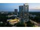 Expansive aerial view of high-rise building, featuring a tennis court and lush landscape within a vibrant city at 2795 Peachtree Ne Rd # 2101, Atlanta, GA 30305