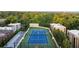 Aerial of tennis court surrounded by lush green trees and a building at 2795 Peachtree Ne Rd # 2101, Atlanta, GA 30305