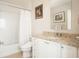 Bathroom offers a shower-tub combo, granite countertop, and white cabinets at 2795 Peachtree Ne Rd # 2101, Atlanta, GA 30305