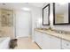 Bathroom with granite counters, dual sinks, and a seamless glass shower with a tub at 2795 Peachtree Ne Rd # 2101, Atlanta, GA 30305