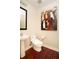 Powder room featuring a stylish pedestal sink, an elegant mirror, and a unique wall painting at 2795 Peachtree Ne Rd # 2101, Atlanta, GA 30305