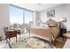 Bedroom with large window view of the city, a decorative bed and stylish writing desk at 2795 Peachtree Ne Rd # 2101, Atlanta, GA 30305