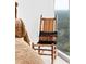 Bedroom features scenic views from the window and a cozy rocking chair with a decorative pillow at 2795 Peachtree Ne Rd # 2101, Atlanta, GA 30305