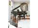 Elegant living room showcasing a grand piano, hardwood floors, and stylish decor at 2795 Peachtree Ne Rd # 2101, Atlanta, GA 30305