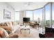 Cozy living room with floor-to-ceiling windows, hardwood floors, and comfortable seating at 2795 Peachtree Ne Rd # 2101, Atlanta, GA 30305
