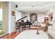 Elegant living room showcasing a grand piano, hardwood floors, and stylish decor at 2795 Peachtree Ne Rd # 2101, Atlanta, GA 30305