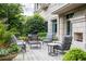 Outdoor patio with comfortable seating, dining table, fireplace, and landscaped garden at 2795 Peachtree Ne Rd # 2101, Atlanta, GA 30305