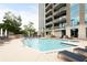 Outdoor pool with sundeck, lounge chairs, and clear blue water with building in background at 2795 Peachtree Ne Rd # 2101, Atlanta, GA 30305