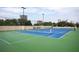 Well-maintained tennis court surrounded by trees and buildings, showcasing a recreational amenity at 2795 Peachtree Ne Rd # 2101, Atlanta, GA 30305