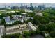 Scenic aerial shot of a community near a vibrant skyline, surrounded by lush trees and landscaping at 3481 Landen Pine Ne Ct, Atlanta, GA 30305
