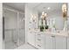 Bright bathroom featuring double vanity with marble countertop, framed mirrors, and a glass enclosed shower at 3481 Landen Pine Ne Ct, Atlanta, GA 30305