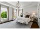 Tranquil bedroom with a tray ceiling, decorative chandelier, large windows and mirrored night stands at 3481 Landen Pine Ne Ct, Atlanta, GA 30305