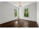 Spacious bedroom featuring hardwood floors, natural light through windows, and an elegant chandelier at 3481 Landen Pine Ne Ct, Atlanta, GA 30305