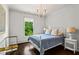 Charming bedroom with hardwood floors, large windows offering natural light, and stylish chandelier at 3481 Landen Pine Ne Ct, Atlanta, GA 30305