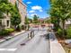Community entrance gate featuring brick buildings and manicured greenery under a bright blue sky at 3481 Landen Pine Ne Ct, Atlanta, GA 30305