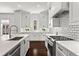Gourmet kitchen featuring white cabinets, stainless steel appliances, and a subway tile backsplash at 3481 Landen Pine Ne Ct, Atlanta, GA 30305