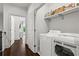 Convenient laundry room with front load washer and dryer, built in storage shelves, and views to the exterior at 3481 Landen Pine Ne Ct, Atlanta, GA 30305