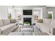 Bright and airy living room featuring dual sofas, a fireplace, large windows, and elegant decor at 3481 Landen Pine Ne Ct, Atlanta, GA 30305