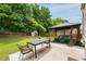 Large backyard with a gazebo over outdoor seating and a dining table at 6378 Grey Fox Way, Riverdale, GA 30296
