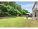 Spacious backyard with a shed and a table with a gazebo on a sunny day at 6378 Grey Fox Way, Riverdale, GA 30296
