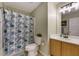 Cozy bathroom featuring a stylish shower curtain and a well-lit vanity area at 6378 Grey Fox Way, Riverdale, GA 30296