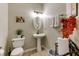 Stylish half bath with pedestal sink, decorative accents, and fresh towels at 6378 Grey Fox Way, Riverdale, GA 30296