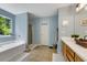 Well-lit bathroom featuring a large soaking tub, shower and a wood vanity at 6378 Grey Fox Way, Riverdale, GA 30296